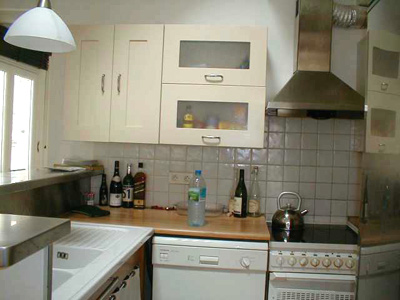 Paris apartment has a full kitchen with a dish washer, stove and oven